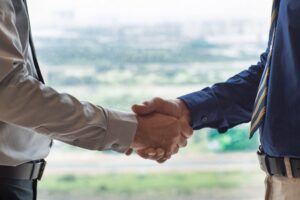 closeup-of-two-businessmen-shaking-hands_1262-1766