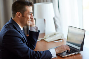 businessman with laptop and smartphone at hotel